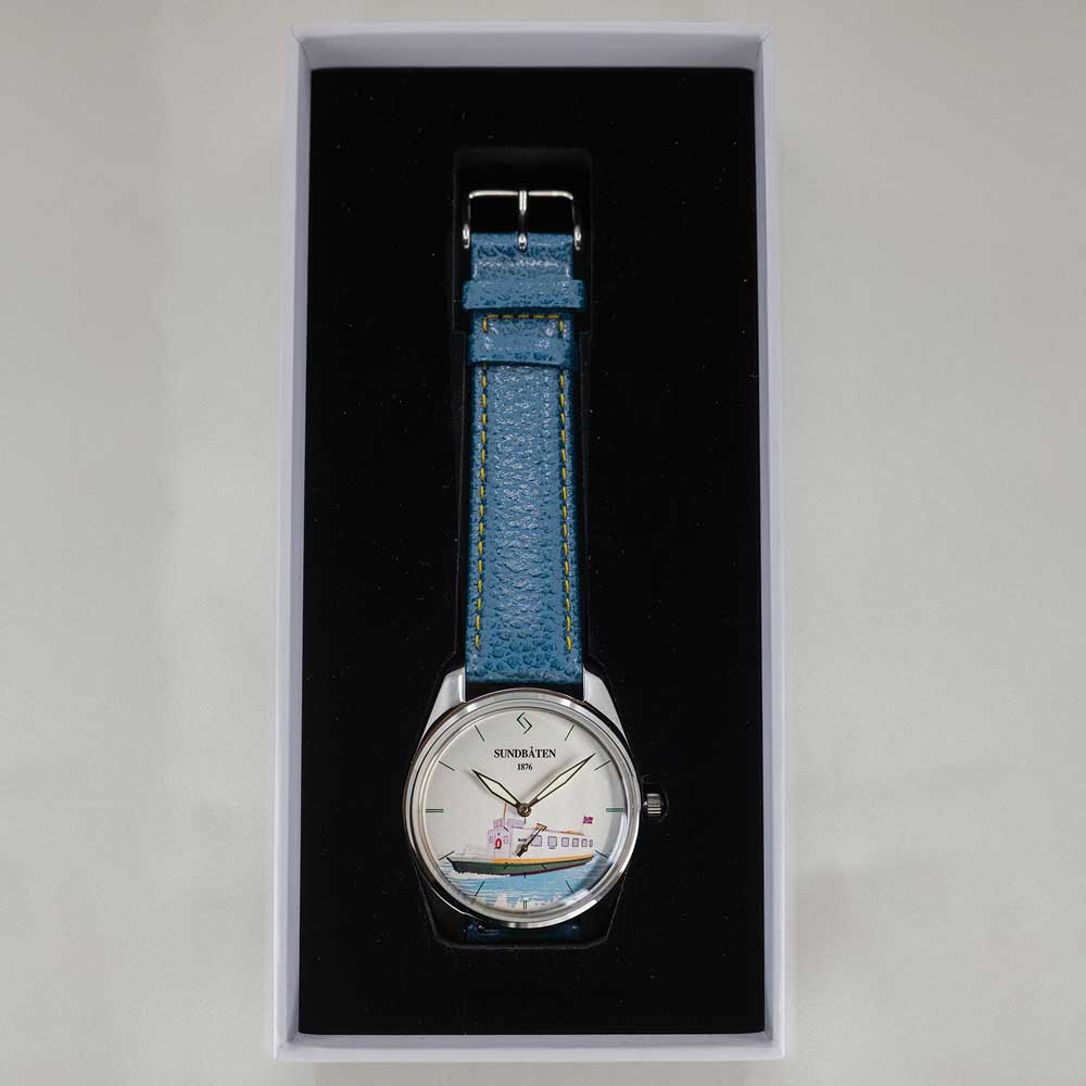 Klokke med blå reim i salgsesken