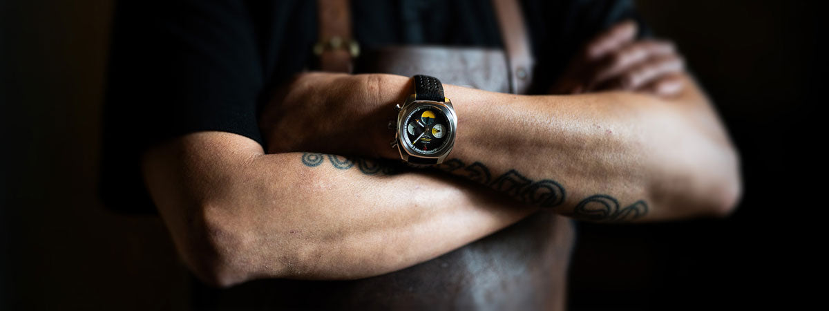 Von Doren watch on a chef’s crossed, tattooed arms.