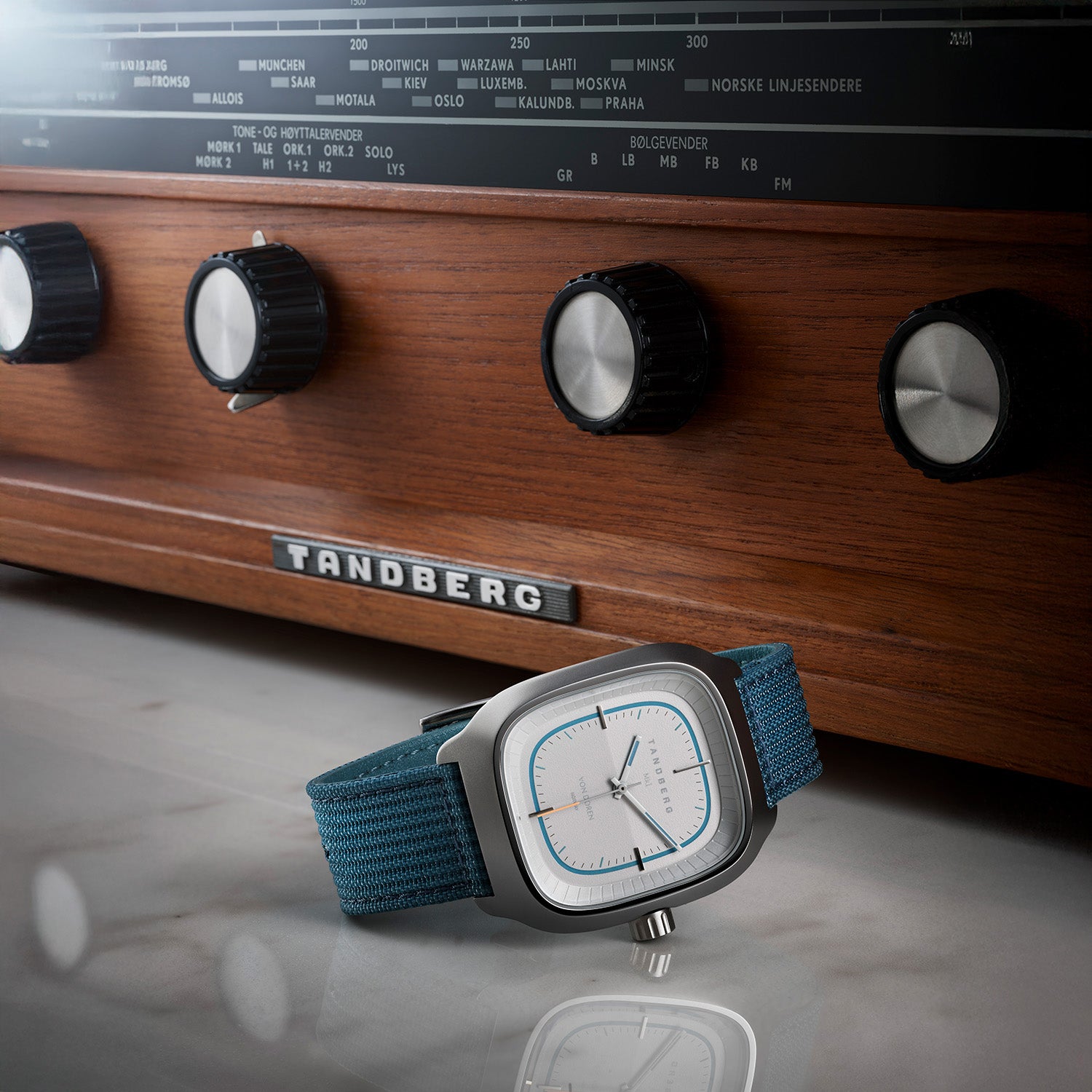 Von Doren Tandberg MKI watch with a blue fabric strap placed in front of a classic wooden Tandberg radio.