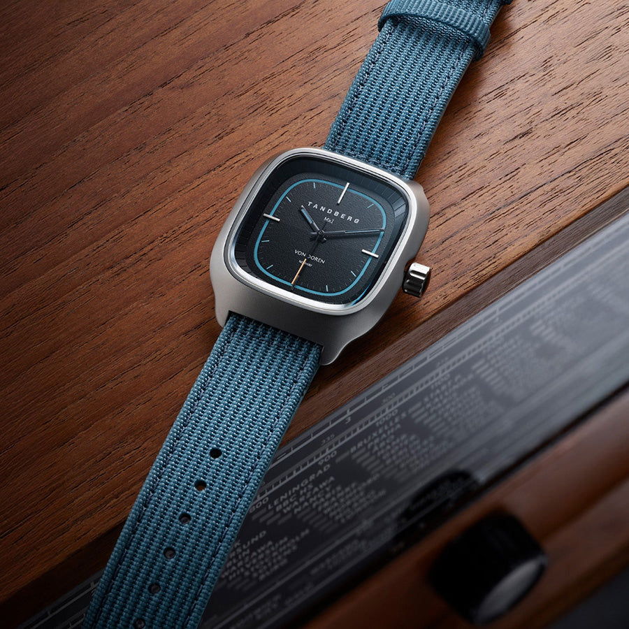 Von Doren Tandberg MKI with a blue fabric strap resting on a classic wooden Tandberg radio.